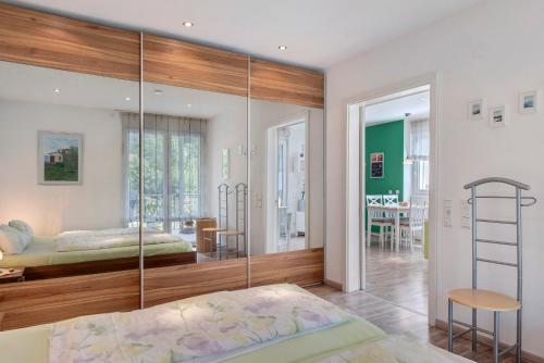 a bedroom with a bed and a glass wall at Ferienwohnung Paffendorf in Gutach