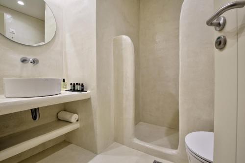 a bathroom with a shower and a sink and a toilet at KOKOON in Parikia