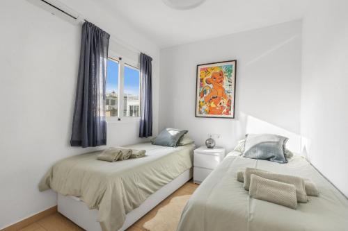 a bedroom with two beds and a window at Casa Karlsen in Ciudad Quesada