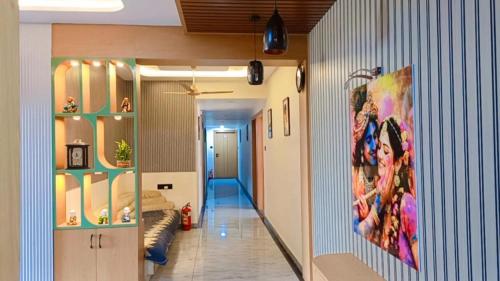 a room with a hallway with a painting on the wall at Hotel Harmony Inn in Ahmedabad