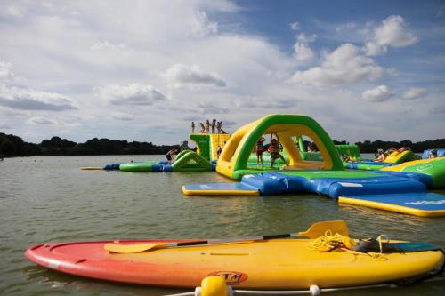 a group of inflatable play structures in the water at Camping 3 étoiles - ccbfige in Pouancé