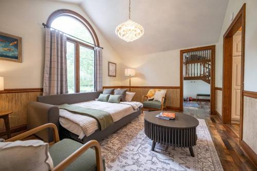 a bedroom with a bed and a living room at Lakefront Group Stay, Sleeps 19, Indoor Pool, Hot Tub, Arcades in Terre Haute