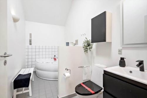 a white bathroom with a toilet and a sink at 746-Hvide-Sande-Slusen-46 in Hvide Sande