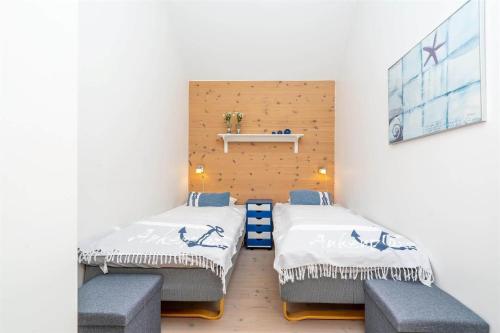a room with two beds and two benches in it at 746-Hvide-Sande-Slusen-46 in Hvide Sande