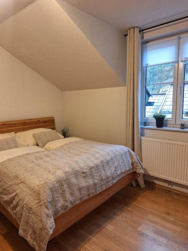 a bedroom with a large bed and a window at Appartement Urlaub Exklusiv in Lackenhof