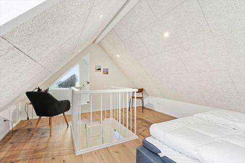 a bedroom with a bed and a desk and a chair at 9952-Hvide-Sande-Langsand-204 in Hvide Sande