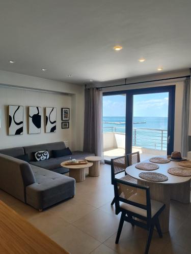 a living room with a couch and a table at Vista mare by Oikies Rentals in Neoi Epivates