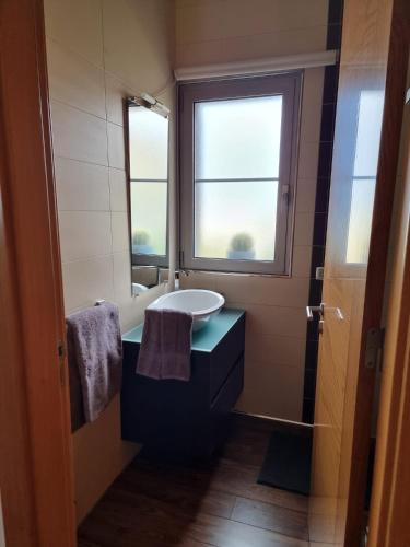 a bathroom with a sink and a tub and a window at Sol e Luna in Ponta