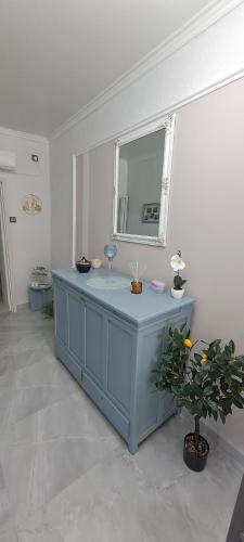 a blue cabinet in a room with a mirror at Casa Chinook Sea View Homes-Porto Koufo in Porto Koufo