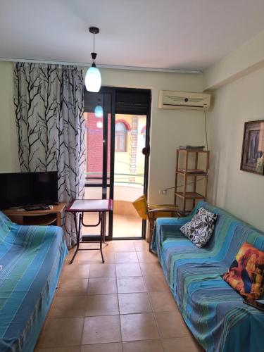 a room with two beds and a table and a desk at Holiday Apartment 70meters from the sea in (( Stan i Ri ))