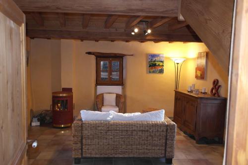 a living room with a couch and a table in a room at La Grunonde in Palogneux
