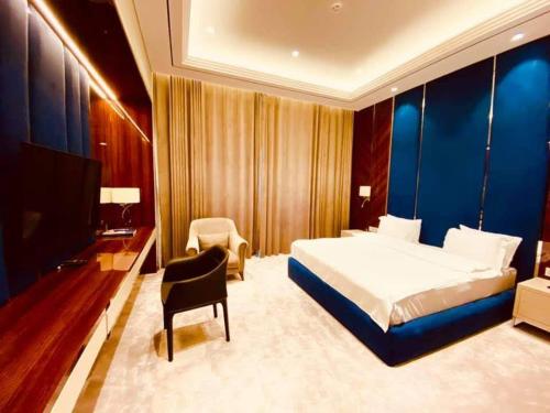 a bedroom with a bed and a desk and a tv at Chorchaman Hills in Patkunob