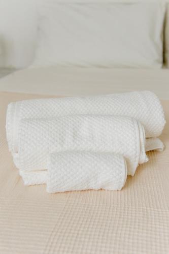 two white towels sitting on top of a bed at La Stazione Formia in Formia