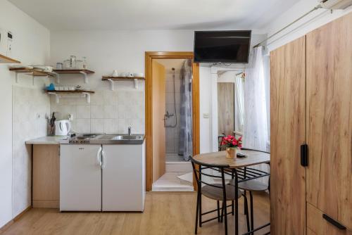 a small kitchen with a table and a sink at Guest House Matana Pomena in Pomena