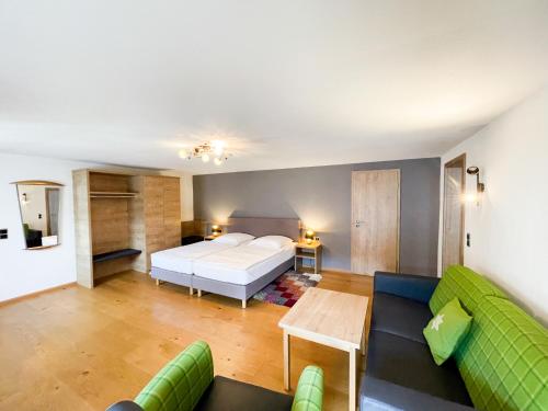 a living room with a bed and a couch at Boardinghouse Sonne in Offenburg