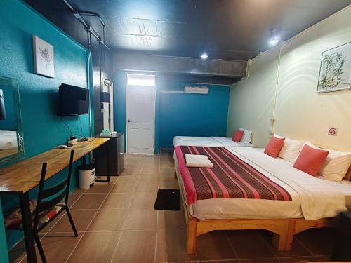 a bedroom with a bed and a desk in it at Ora House in San Kamphaeng