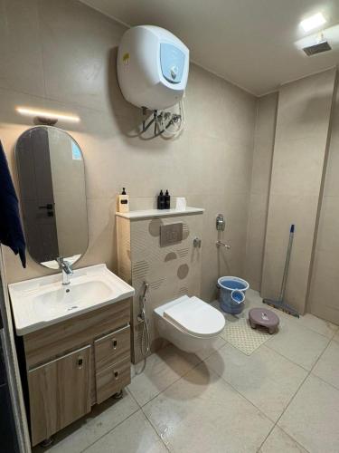 a bathroom with a toilet and a sink and a mirror at Jsrcozystays in Rājpur