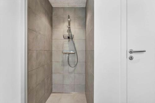 a shower with a shower head in a bathroom at 945-Hvide-Sande-Langsand-163 in Hvide Sande