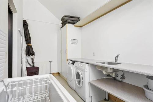 a white laundry room with a sink and a washing machine at 704-Hvide-Sande-Slusen-4 in Hvide Sande
