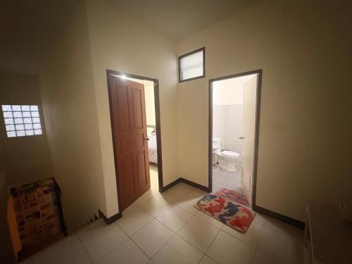 a room with a bathroom with a toilet and a door at Maolao bar and hotel in Pai