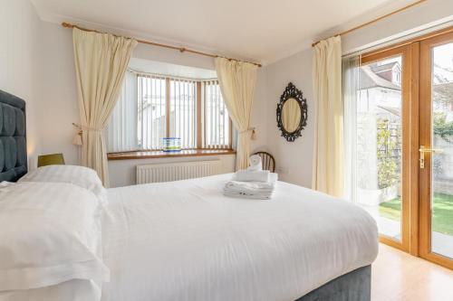 a white bedroom with two beds and a window at 1 Bed in Bishopston oc-hh654 in Bishopston