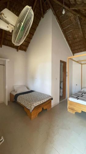 a bedroom with a bed and a mirror in it at Timonier Ecolodge in Mar Lodj
