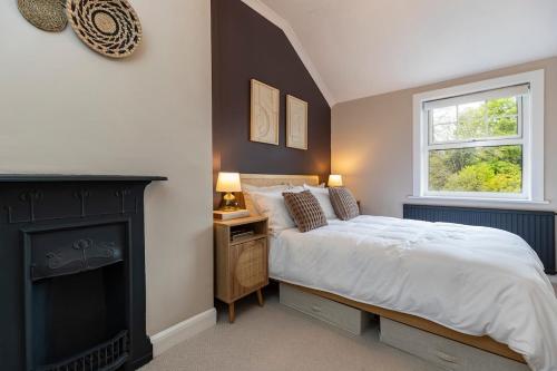 a bedroom with a bed and a fireplace at 2BR House By Cozy Quarters Property Management Holiday Lets Sedgefield With Open Field & Countryside Views in Sedgefield
