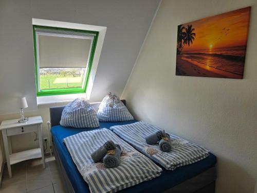 a bedroom with a bed with two stuffed animals on it at Ferienwohnung Kloster Tempzin 19412 in Tempzin