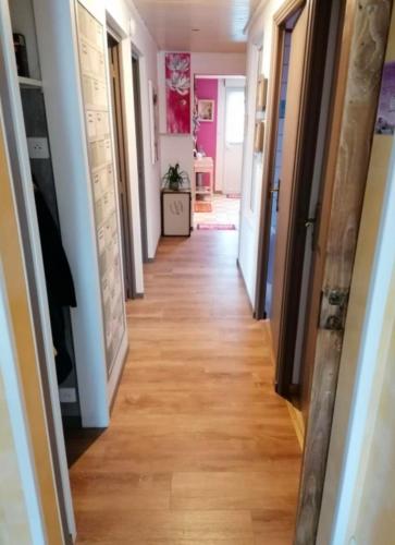 a hallway of a home with a floor of wood at Gîte Le Chemin du Cap in Plévenon
