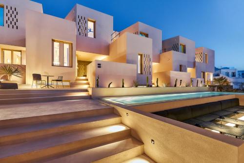 a house with a swimming pool in front of it at Enorme EOS Santorini - Adults Only in Pyrgos