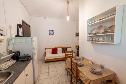 a kitchen and dining room with a table and a room at Apartment's Eleni in Kamena Vourla