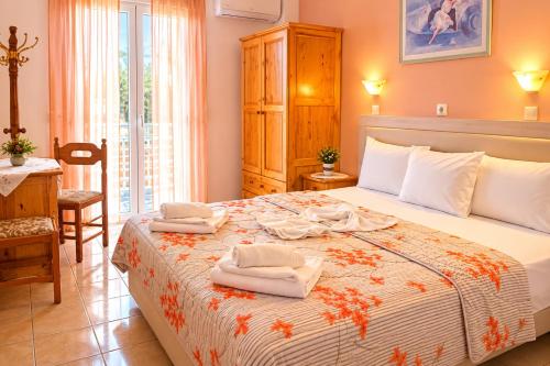 a bedroom with a large bed with towels on it at Annamaria Studios & Apartments in Petra