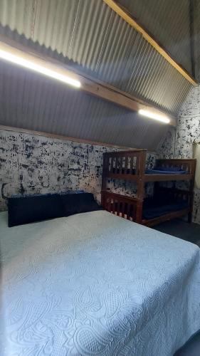 a bedroom with a large bed with a white bedspread at Chale mundo da Lua 2 in Piedade