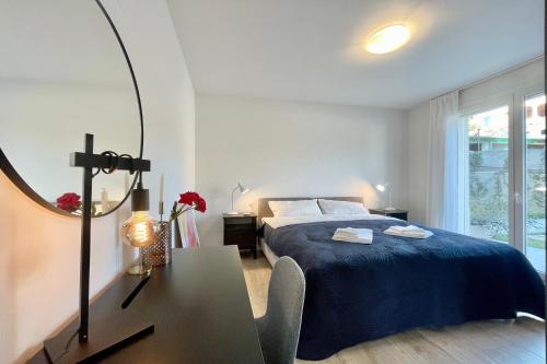 a bedroom with a bed and a table and a mirror at Condominio Modern House in Menaggio