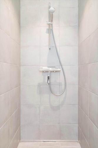 a shower with a shower head in a bathroom at 944-Hvide-Sande-Langsand-143 in Hvide Sande