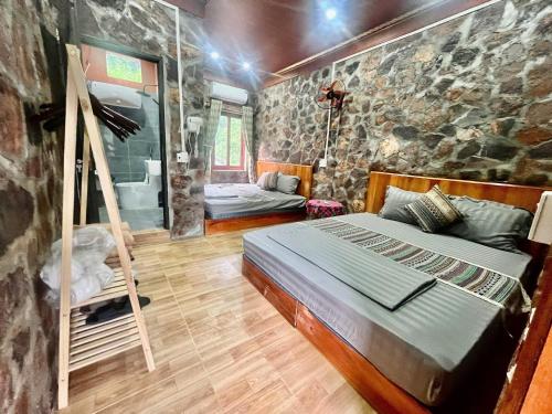 a bedroom with a bed and a ladder in it at A THÁM homestay in Dam Thuy