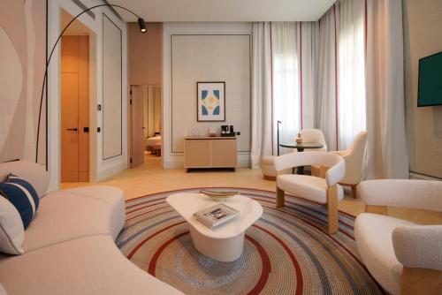 a large living room with white furniture and a living room at Áurea Palacio de la Tinta by Eurostars Hotel Company in Málaga