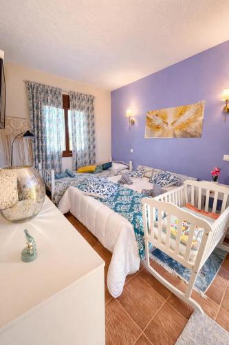 a bedroom with two beds and a crib at Angelparadise village stefani in Stefáni
