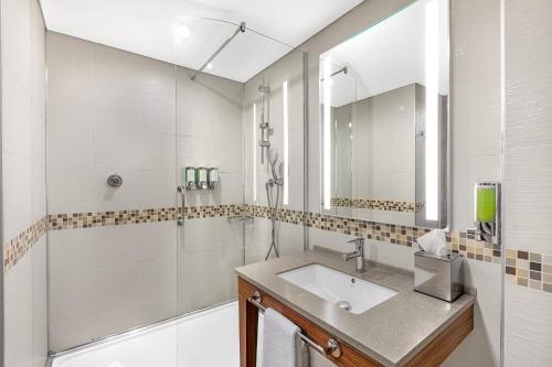 a bathroom with a sink and a shower at Hampton by Hilton Istanbul Kayasehir in Istanbul