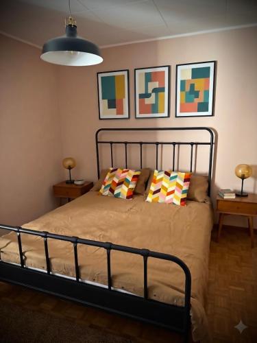 a bedroom with a bed with two pillows on it at Appartamento Lucia in Ampezzo