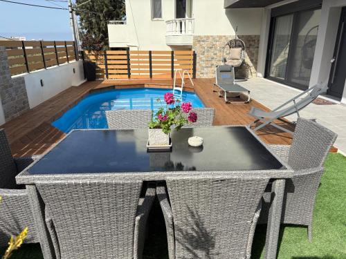a patio with a table and a swimming pool at Emma - Elena Peris Villas, By Idealstay Experience in Gouves