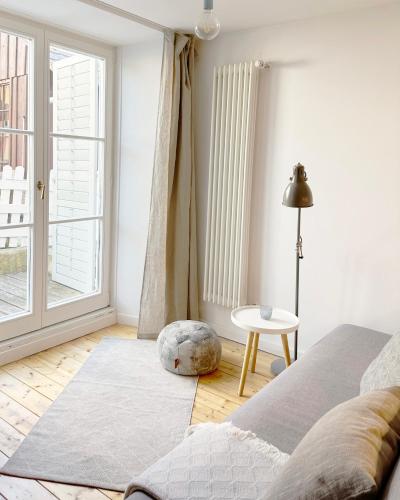 a living room with a bed and a window at Haus Münsterblick in Reichenau