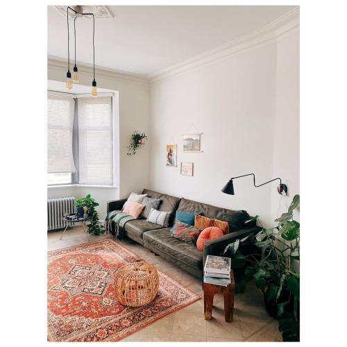 a living room with a couch and a rug at Centrally located spacious family home in Tienen