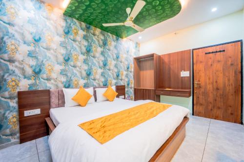 a bedroom with a bed and a floral wall at Hotel Neel Kamal-Near KhatuShyamJi Temple in Khātu