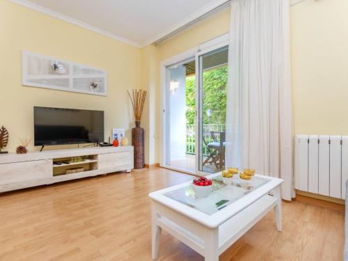 a living room with a tv and a white coffee table at Apartment Buenos Aires by Interhome in Lloret de Mar