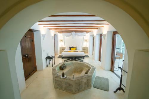 a large bathroom with a tub in a bedroom at Adigars Manor Kandy - A Boutique Heritage Hotel Built in 1804 in Kandy