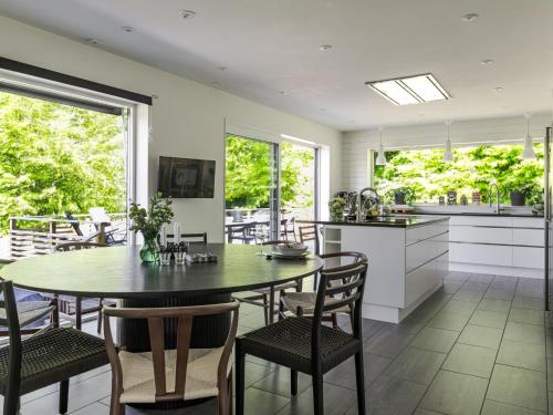 a kitchen and dining room with a table and chairs at Villa Villa Anja by Interhome in Asarum