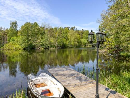a boat tied to a dock next to a street light at Villa Villa Anja by Interhome in Asarum