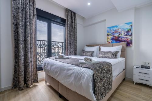 a bedroom with a large bed and a window at Daylights Apart Otel in Antalya