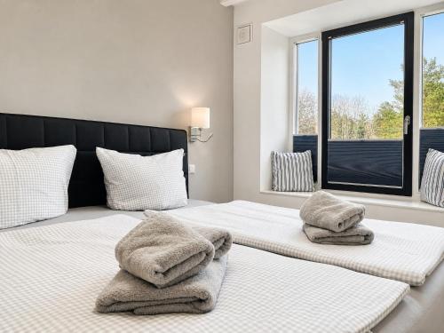 a bedroom with two beds with towels on them at Ferienwohnung Meeresblick Haus Granitz in Prora in Binz